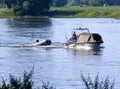 Leisure angler goes with a small motor boat with attached dinghy to the fishing place in the Elbe
