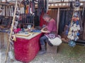 Magdeburg, Germany - 29.08.2014: Kaiser-Otto-Fest. Reconstruction of historical events of the city. Tanner sews a needle leather