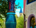 Single blue rounded support at the corner of the green citadel, a residential building, commercial building and hotel of the