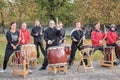 Warm-up before a marathon. Gruppe of the drummers plays rhythmic music for runners. Leisure sports activities for people