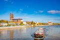 Magdeburg historical downtown, Elbe river, the ancient medieval cathedral with coming by a big cargo ship, barge, in golden Autumn