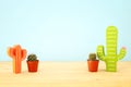 mage of cactus in a pot infront of wooden blue background. Royalty Free Stock Photo