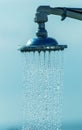 Mage of a vintage old shower head splashing water close up background. Water flows from the head of an old shower. Background for