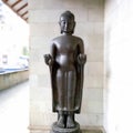 Magelang 7 September 2023 Black Buddha statue with folded hands in front of nails standing at Mendut Pawon temple in the morning Royalty Free Stock Photo