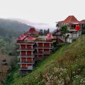 Magelang 14 September 2023 Buildings on cliffs with tile roofs. White skies, mountains, green trees on Jalan Magetan Solo