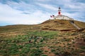 The Magellanic penguins with the Lighthouse of Magdalena Island background,