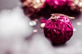 Magenta christmas ball on bokeh background of xmas ornaments. Royalty Free Stock Photo