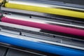 Magenta, cyan and yellow toner cartridges for color laser printers stacked on gray wooden background Royalty Free Stock Photo