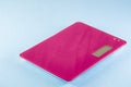 Magenta Digital Kitchen Scale on blue background Royalty Free Stock Photo