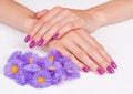 Magenta fingernails and purple flowers