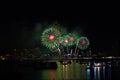 magenta green fireworks on beach and reflection color on water surface Royalty Free Stock Photo