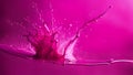 Magenta paint splatter hittong a surface producing abstract art