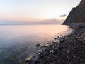 Magenta sunset on tropical beach slowshutter speed milkwater surface