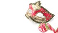 Magenta venetian carnival mask, on white table with some stream Royalty Free Stock Photo