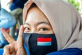 faces of young Indonesian women wearing masks to prevent the spread of covid-19