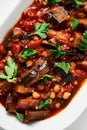 Maghmour or Lebanese moussaka. Dish made from baked or fried eggplant with spices, chickpeas and tomato sauce. Eggplants