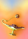 Magic Antique Aladdin Lamp on a beautiful orange background. Close up. flat lay. Royalty Free Stock Photo