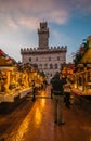 Magic atmosphere in the main square of Montepulciano with christmas market at sunset on winter rainy day