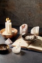 Magic book, sage, burning candles and ritual staff Royalty Free Stock Photo