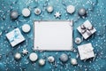 Magic christmas background. Frame with xmas decoration, gift box, confetti and silver sequins on vintage blue table top view. Royalty Free Stock Photo