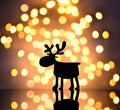 Magic christmas background with christmas lights and silhouette deer at night