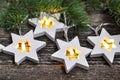 Magic Christmas theme: cozy warm lights garland stars and fir branches on rustic wooden background. top view. over hand Royalty Free Stock Photo
