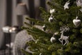 Magic Christmas tree decorated with beautiful deer-shaped toy and other silver toys.