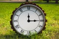 Magic clock on the green lawn.Clock on the green grass