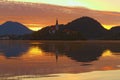 Magic colors during sunrise on Lake Bled. Pilgrimage Church of the Assumption of Maria and mountain range reflected in water. Royalty Free Stock Photo