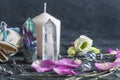 Magic composition with pink candle, crystals, pagan bag and flowers. Esoteric and pagan rituals, witchcraft Wiccan or spiritual