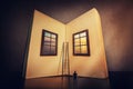 The magic, giant open book with two windows leading to another mystic world. Tiny man look at the textbook blank sheets ready to Royalty Free Stock Photo