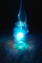 Magic in a jar on a dark background Royalty Free Stock Photo