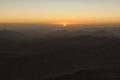 Magic golden sunrise in the mountains. The sun comes out from the cloud. View from Mount Sinai Mount Horeb, Gabal Musa
