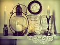 Lunar phases diary, burning candles, pentagram on the wall and old-fashioned lamp