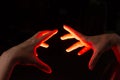 Magic hands cast spells at each other, silhouetted in a reddish glow Royalty Free Stock Photo