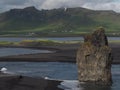 Magic iceland landscape with black lava sand and green eroded hills Royalty Free Stock Photo