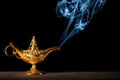 Magic lamp on black background from the story of Aladdin with Genie appearing in blue smoke concept for wishing, luck and magic Royalty Free Stock Photo