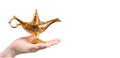 Magic lamp on female hand isolated on white background. Concept for wishing, luck and magic. Fairy tale banner