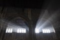 Magic light rays entering with some mist on a Gothic old Cathedral interior scene in the Cotswolds Royalty Free Stock Photo