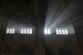Magic light rays entering with some mist on a Gothic old Cathedral interior scene in the Cotswolds, England Royalty Free Stock Photo