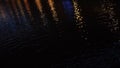 Magic night scenery. Concept. Close-up of pond dark water surface during the night with reflection from city lights. Royalty Free Stock Photo