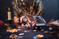 Magic and online fortune telling. The witch is holding a watch on a chain and a smartphone. Close up