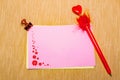 magic pen and paper note with red flowers and paperclip on yellow background, minimal concept and similarities differences Royalty Free Stock Photo