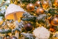 Magic pink and porcini mushrooms and a lot of Christmas balls on the Christmas tree. New Year mood. Festive Christmas toys. Royalty Free Stock Photo