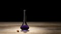Magic potion on wooden table. Corked bottle of mysterious liquid