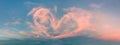 Love - real heart made from clouds in the sunset sky. Pink light heart shaped clouds