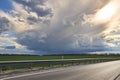 Magic sky with dark clouds and the sun above the road Royalty Free Stock Photo