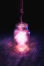 Magic in a jar on a dark background Royalty Free Stock Photo