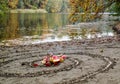 Magic spiral works next to a lake, wicca altar. Pagan religion.