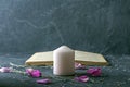 Magic still life with pink candle and old herbalist book. Esoteric and pagan rituals, witchcraft Wiccan or spiritual practice